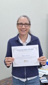 Award Winner holding Trailblazer Award certificate