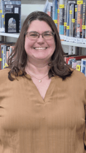 Photo of award winner standing in front of a bookcase.